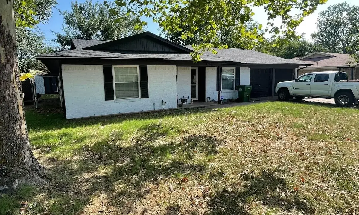 Professional roofing crew working on a residential roof in Auburn
